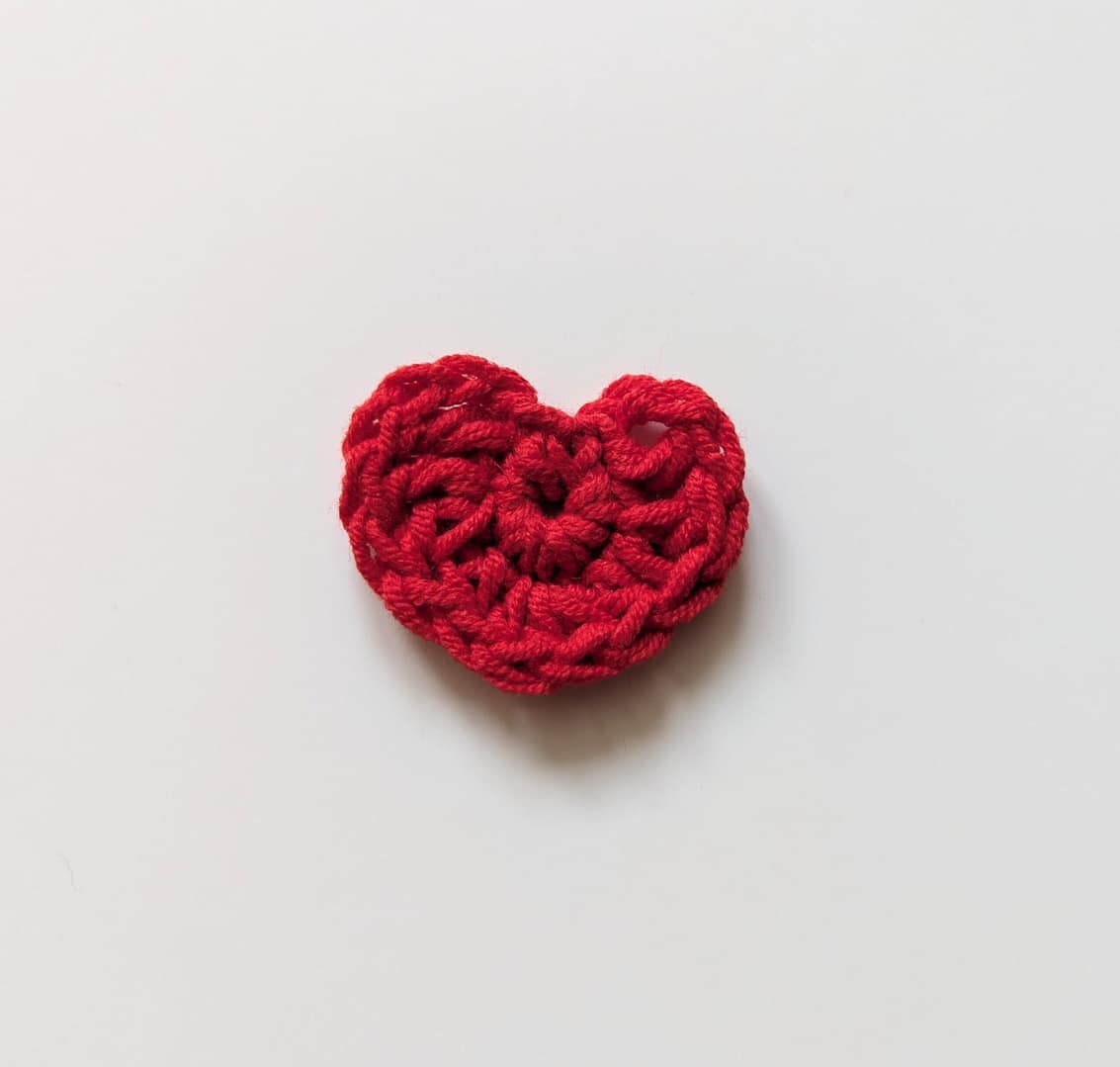 A small red crocheted heart