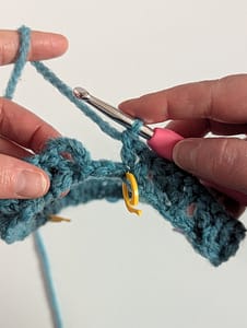 Close up crochet stitches in blue yarn
