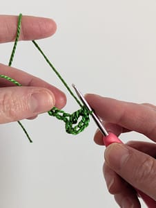 One double crochet stitch worked into foundation chain stitch in green yarn