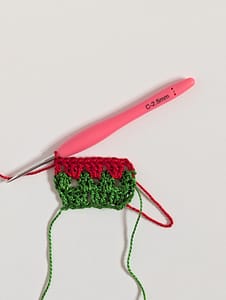 Three rows of granny stripe crochet pattern in green and red yarn