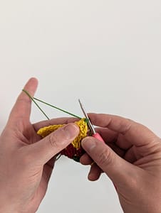 green yarn attached to a row of crochet in yellow yarn