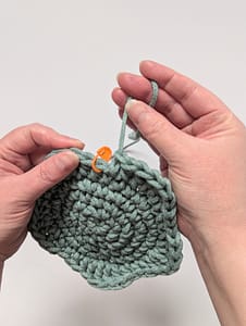 The last loop of a crochet stitch being pulled through to end the piece