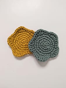 2 crochet coasters in the shape of a star on a white background