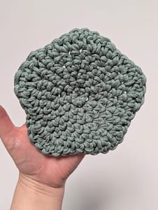 The back of a crochet coaster in the shape of a star