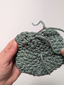 Yarn tail being weaved in to finish