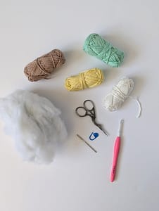 Yarn, crochet hook, stitch marker, yarn needle, embroidery scissors and toy stuffing